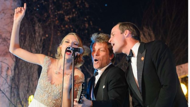Britain's Prince William (right) sings with US musician Taylor Swift (left) and Jon Bon Jovi (centre) at the Centrepoint Gala Dinner at Kensington Palace in London, in November 2013
