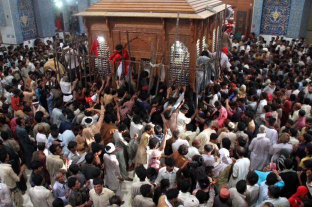 Pakistani devotees gather on 18 June, 2014 at the shrine of 13th century Muslim Sufi saint Lal Shahbaz Qalandar, in Sehwan