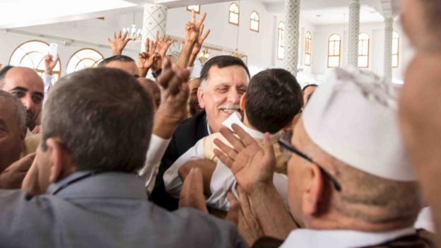 Unity government head Fayez Seraj meets a man inside a mosque after Jumma prayers during a tour in Tripoli city, Libya April 1, 2016.