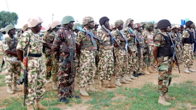 A handout picture taken on June 9, 2015 by the Nigerian Army and released on June 11, shows troops standing to listen to Chief of Army Staff, Lieutenant General Kenneth Minimah