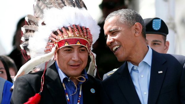 U.S. President Barack Obama talks to the Standing Rock Sioux Tribe Chairman David Archambault II (L) as they attend the Cannon Ball Flag Day Celebration at the Cannon Ball Powwow Grounds on the Standing Rock Sioux Reservation in North Dakota, June 13, 2014