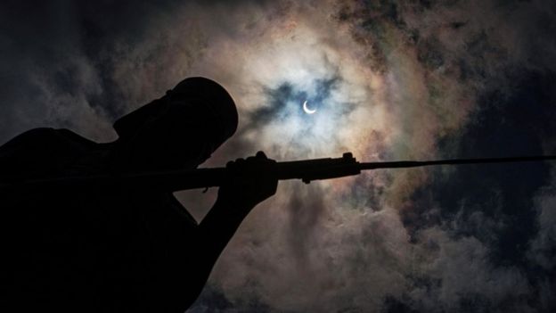 The eclipse is seen behind the Askari monument in Dar es Salaam, Tanzania.