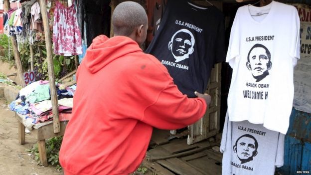 Customer looks at Obama shirts at a stall in Nairobi's Kibera slums, 23 July 2015