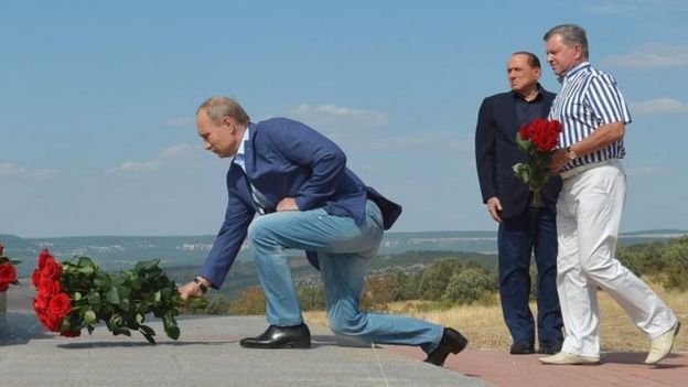 Russian President Vladimir Putin (left) and former Italian Prime Minister Silvio Berlusconi (second on the left) visit an Italian war cemetery near the Black Sea port of Sevastopol