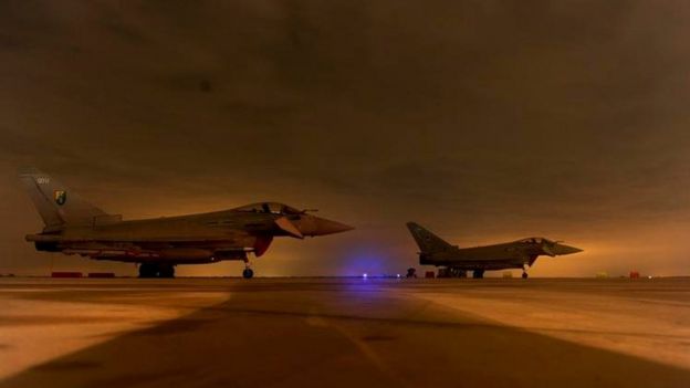 RAF Typhoons wait to be serviced after their first mission over Libya in March 2011