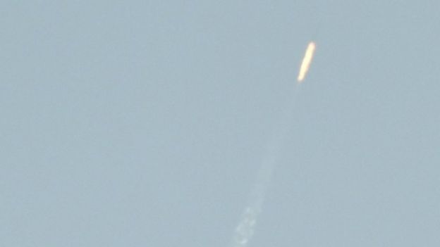 A flying object soars into the air above North Korean territory as seen from the Chinese border city of Dandong, 7 February