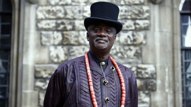 Nigerian tribal king Emere Godwin Bebe Okpabi poses for a photograph following an interview in central London