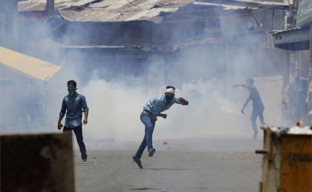 Kashmiri Muslim protesters throw stones at Indian paramilitary soldiers in Srinagar, Indian controlled Kashmir, Sunday, July 10, 2016.