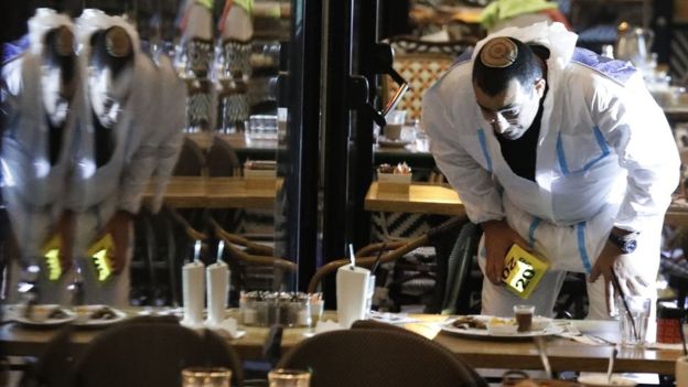 Israeli forensic police officer inspects a restaurant after a shooting at Sarona Market, Tel Aviv, on 8 June 2016