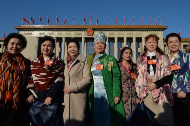 Chinese Uighur delegates from Xinjiang province arrive for the first session of the National People's Congress (NPC) at the Great Hall of the People in Beijing on 5 March 2014.