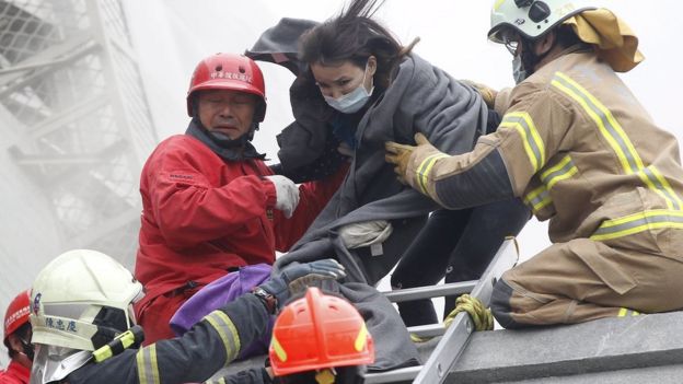 Rescuers help a survivor escape the collapsed building in Tainan, Taiwan, on 6 February 2016
