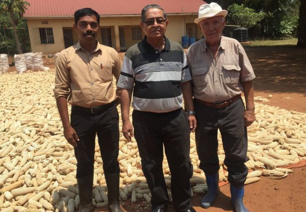 Nizar Sayani pictured with two workers on his farm