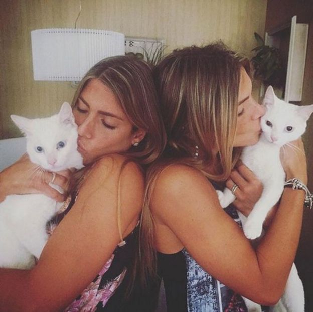 Bia and Branca Feres seen cuddling two kittens