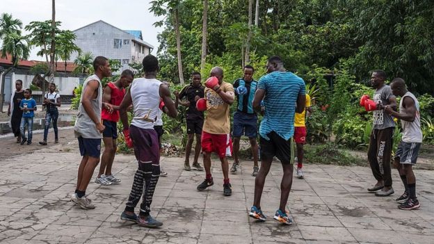 People practice boxing in the surroundings of Tata Raphael Stadium in Kinshasa on December 18, 201