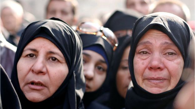 Women react as they wait outside a government military police centre to visit their relatives, who were evacuated from the eastern districts of Aleppo and are being prepared to begin their military service, in Aleppo, Syria December 11, 2016