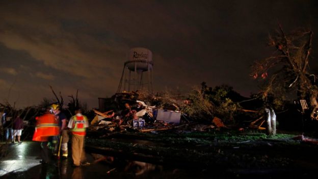 A water tower still stands near a neighborhood on Pebble Beach Drive that sustained heavy damage after a tornado touched down Saturday, Dec. 26, 2015