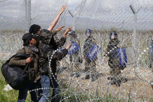 Migrants face Macedonian police on the Greek border at Idomeni, 10 April