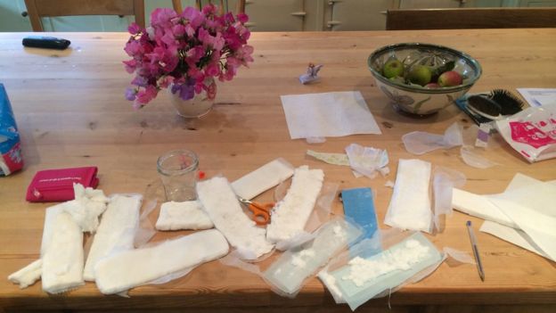 Amy Peake's kitchen table covered in sanitary pads