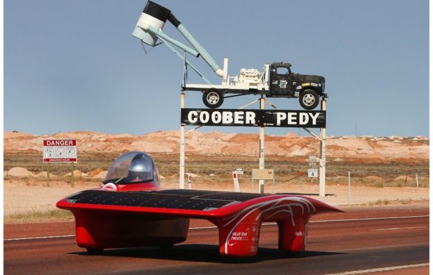 A handout photo taken and received on 21 October 2015, shows Red One of Solar Team Twente Netherlands leaving Coober Pedy as they race on day four in the Cruiser Class of the 2015 World Solar Challenge