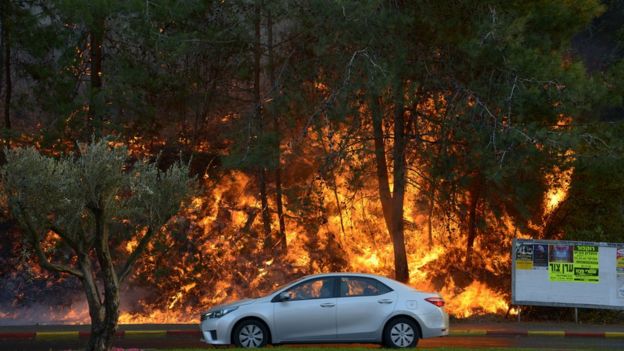 Car passing fire in Haifa