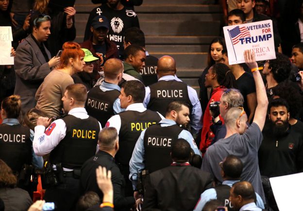 A demonstrator is removed by Chicago police during a rally for Republican presidential candidate Donald Trump at the University of Illinois at Chicago Pavilion in Chicago on Friday, March 11, 2016.