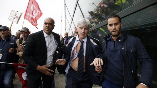 Mr Plissonnier, director of Air France at Orly airport, was eventually led to safety with his shirt torn