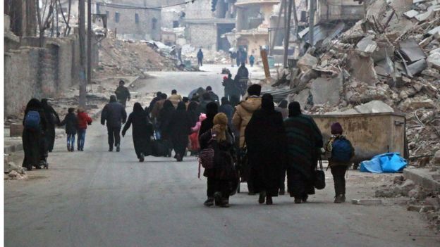 Syrian civilians flee the Sukkari neighbourhood towards safer rebel-held areas in south-eastern Aleppo, on 12 December 2016, during an operation by Syrian government forces to retake the embattled city.