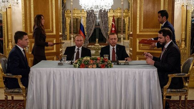 Russian Energy Minister Alexander Novak (L) and his Turkish counterpart Berat Albayrak (R) sign an agreement, flanked by Russian President Vladimir Putin (2nd L) and Turkish President Recep Tayyip Erdogan, before a press conference in Istanbul on October 10, 2016.