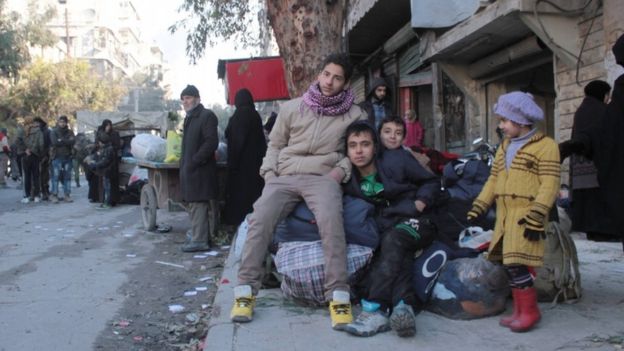 Children sit with their baggage during the evacuation, Aleppo, Syria, 15 December 2016