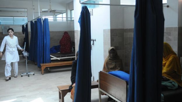 In this picture taken on 3 March 2009 a nurse passing by the beds of fistula patients at Koohi Goth hospital in the outskirts of Karachi.