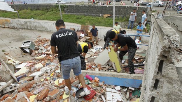 Police sift through debris in Manta, Ecuador, after a massive earthquake