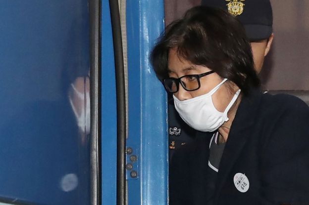 This picture taken on 19 November 2016 shows Choi Soon-sil, the woman at the heart of a lurid political scandal engulfing South Korea's President Park Geun-Hye, being escorted after questioning at the Seoul Central District Prosecutors
