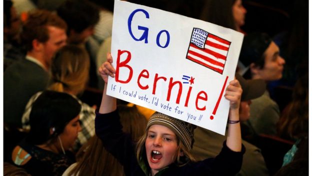 Marlow Mittelstaedt holds a sign and cheers while waiting for the arrival of Democratic presidential candidate Sen. Bernie Sanders, I-Vt.,