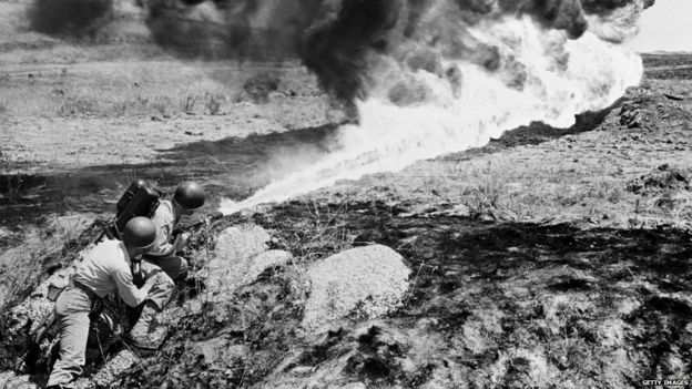 A picture dated circa April 15, 1951 shows marines from the US Allied Forces using a flame-thrower to clean the field during the Korean War.