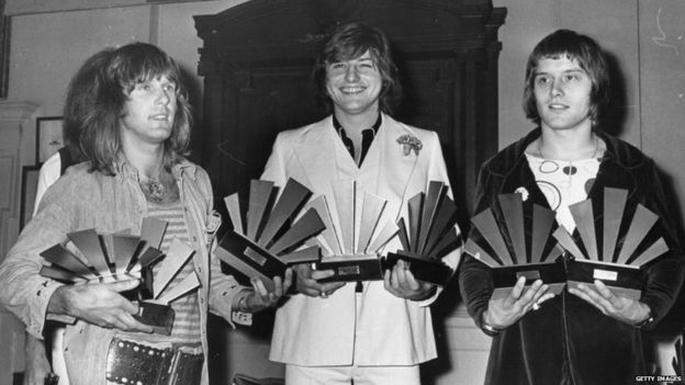 Keith Emerson (left), Greg Lake (centre) and Carl Palmer - Emerson Lake And Palmer - receive awards at the 1972 Melody Maker Pop Poll