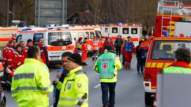 Rescue personnel wait in Bad Aibling, Germany, Tuesday, Feb. 9, 2016, after two regional trains crashed