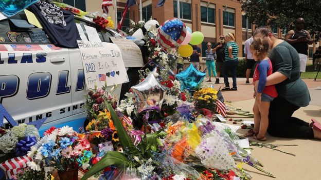 Supporters visit a growing memorial at the Dallas police department's headquarters.