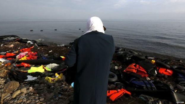 A Syrian woman talks to relatives on her mobile after arriving by sea on the Greek island of Lesbos 21/10/2015