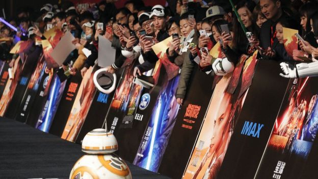 Chinese fans take pictures of the droid character BB-8 at the Shanghai premiere of 