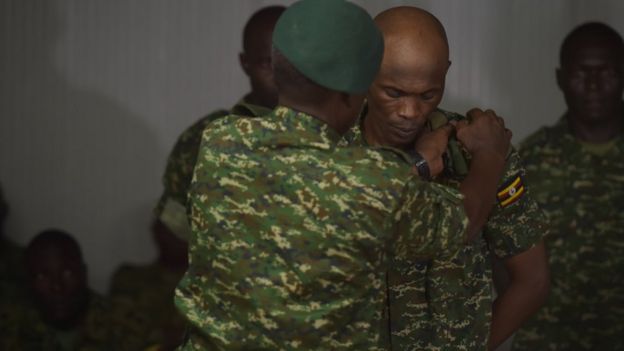 A soldier has his pips removed as he is stripped of his rank after a trail which found him guilty of pursuing personal gain and endangering operational efficiency in Mogadishu, Somalia, on 15 August 2016