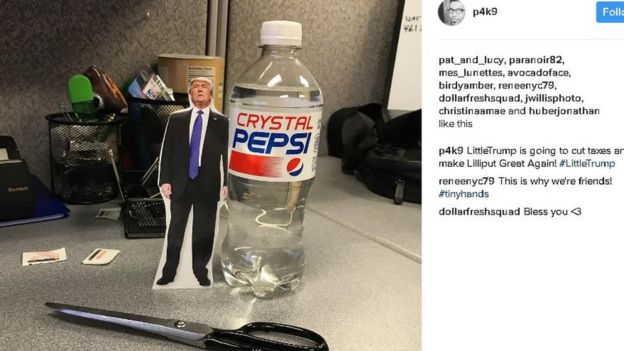 paper cutout of Trump, smaller than the Pepsi bottle it's next to for size comparison; caption reads 