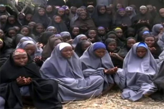 This file photo taken on May 12, 2014 shows a screengrab taken from a video of Nigerian Islamist extremist group Boko Haram obtained by AFP showing girls, wearing the full-length hijab and praying in an undisclosed rural location.