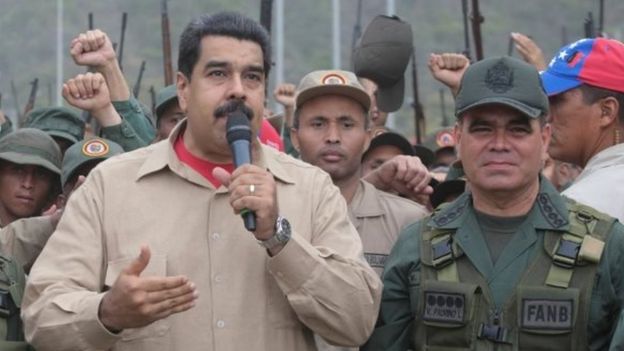 Venezuela's President Nicolas Maduro (centre) talks during a military parade, next to Venezuela's Defence Minister Vladimir Padrino Lopez (right) in La Guaira, Venezuela on 21 May, 2016.