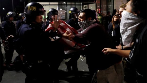 Protesters scuffle with police in Oakland, California, during a demonstration against Donald Trump, 10 November 2016