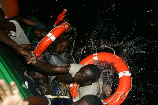 Isa and Ibrahim, both from Mali, being pulled from the water