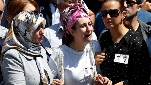 Relatives of police officers Feyyaz Yumusak and Okan Acar, mourn during their funeral procession in Sanliurfa, southeastern Turkey,Thursday, July 23, 2015