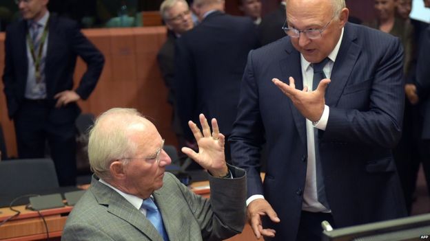 German Finance Minister Wolfgang Schaeuble (left) and French Finance Minister Michel Sapin gesture as they attend an extraordinary Eurogroup meeting on Greece at the European Council in Brussels, 14 August 2015