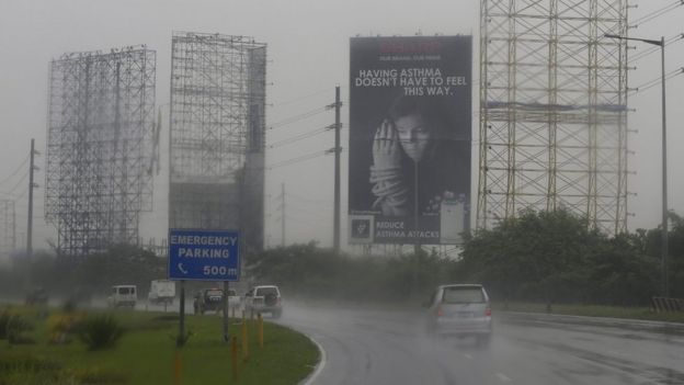 Giant billboards removed in anticipation of typhoon in town of Meycauyan, Bulacan province, Philippines, 17 October 2015.