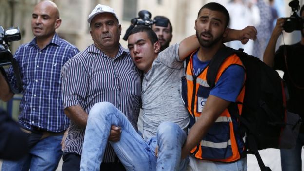 Palestinian youth evacuated after being injured in clashes on 13 September 2015