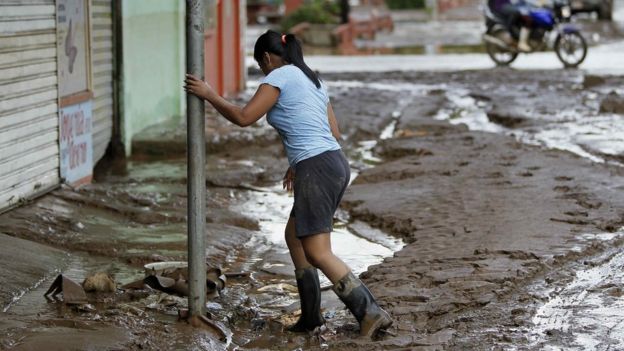 A woman walks in a mud after the hurricane Otto came through Upala, San Carlos, Costa Rica